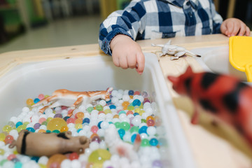 Close-up of kids take orbeez from water
