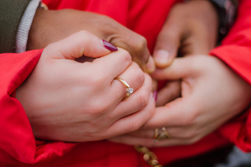 Two lovers are holding hands after proposal