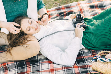 A guy and a girl love each other, smile, hug, kiss, laugh, enjoy life in the forest on a cliff, in...
