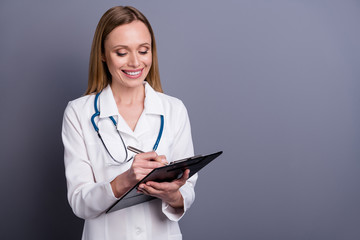 Portrait of her she nice attractive cheerful content focused blonde girl doc specialist therapist assistance clinic filling medical form assistance isolated over grey violet pastel color background