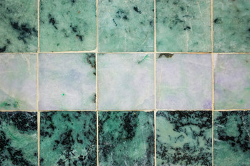 Green Jade marble stone texture, different shades of green jade tiles from Mahamuni Buddha Temple in Mandalay, Myanmar