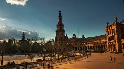 Fototapeta na wymiar Seville, Spain - February 20th, 2020 - North Tower of the Plaza de Espana / Spain Square with Horse Carriages and Tourists Strolling in Seville City Center.