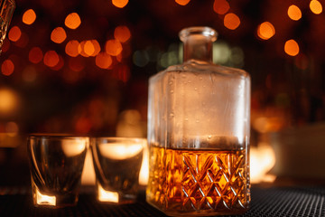 glass wine jar with christmas lights on the table