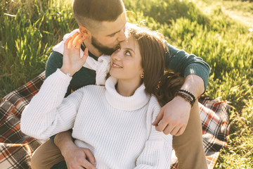 A guy and a girl love each other, smile, hug, kiss, laugh, enjoy life in the forest on a cliff, in...