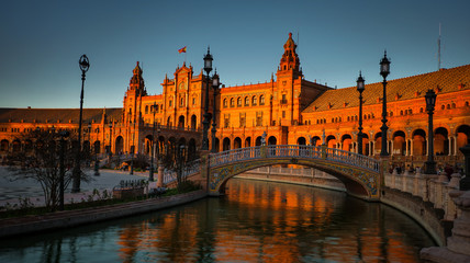 Fototapeta premium Seville, Spain - February 18th, 2020 - Plaza de Espana / Spain Square with a beautiful view of the canal and Architecture Details in Seville City Center, Andalusia.