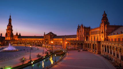 Naklejka premium Seville, Spain - February 20th, 2020 - The famous plaza de Espana / Spain Square in Seville City Center with Architecture Details and beautiful centered fountain.