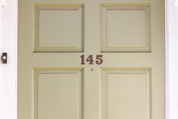 House number 145 on a traditional British wooden front door