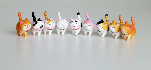Group of small resins cat toy stand on table.
