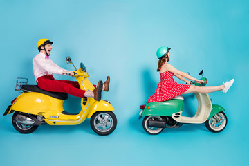 Full length profile photo of crazy lady guy couple drive two retro moped travelers traffic jam easy way spread legs rejoicing having fun vintage clothes caps isolated blue color background
