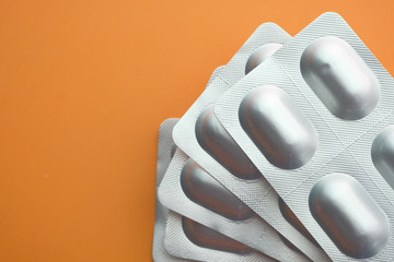 Close up of blister pack on orange background 