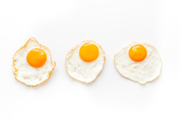 Fried eggs pattern on white background top view