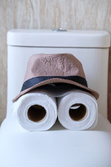 roll of toilet paper and hat, close up 