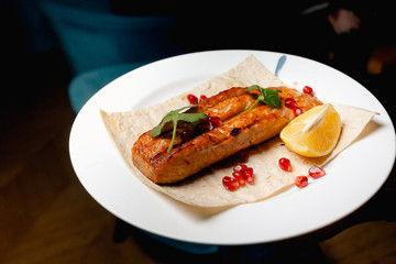 Grilled salmon steak served on pita bread 