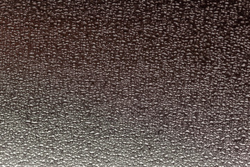 Drops of water on stainless steel close-up. Use as background or texture.