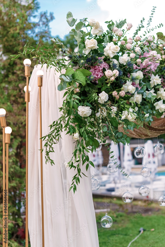 Wall mural arch for the wedding ceremony, decorated with cloth and flowers