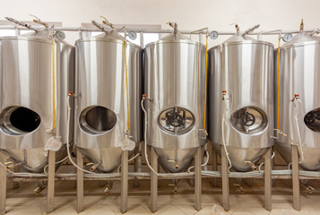 Brewery, five beer tanks, cylinder-conical fermentation tanks, open in three hatchways, closed in two others