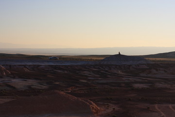 Lonely silhouette meditating on the top of the hill