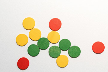 Colorful circles wooden on white background. Geometric shapes red, green, yellow colors, top view. Concept of geometry. Copy space. Children educational logical task. Flat lay.
