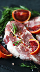 Selective focus. Macro. Raw pork steaks pickled with seasonings and spices. Fresh pork meat.