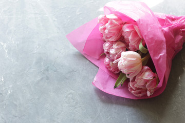 bouquet of pink flowers on a gray table. top view.
