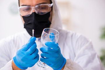 Male expert criminologist working in the lab for evidence