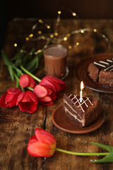 holiday table with cake with candles, cocoa and flowers tulips, quarantined birthday.
