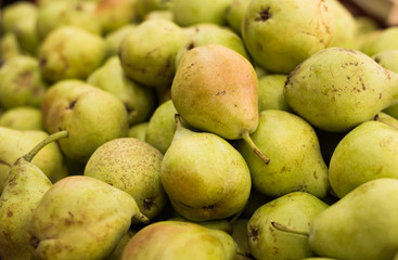 appetizing pears on counter in market