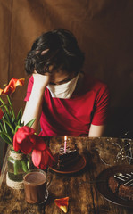 Young man celebrates his birthday during the coronovirus alone, a holiday during the pandemic