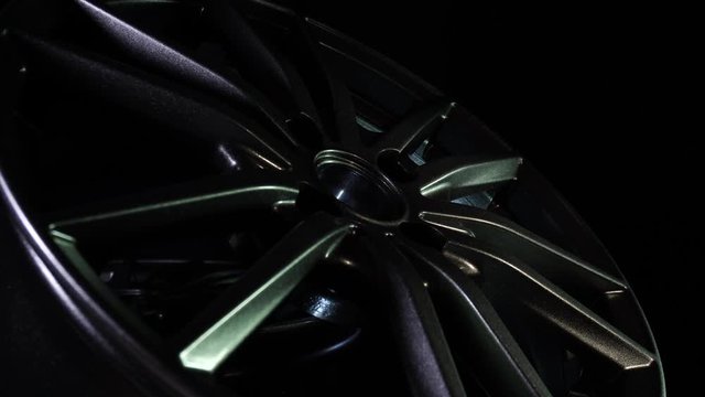 Alloy metal wheels for car in dark background. New modern equipment for auto and vehicle. Expensive bright steel disks made of carbon. Luxury design. Clean aluminium magnesium wheels stand. Cast drive