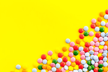 Color candy on yellow tabe top-down frame space for text