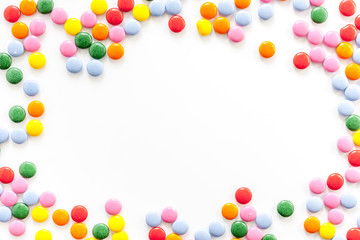 Color candy on white background top view frame copy space
