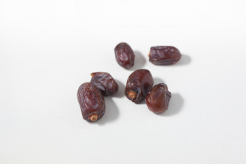 Dried dates fruits on white background, tasted sweet and chewy
