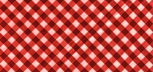 The texture of the bright red of binding gingham fabric. Red textile background. Fabric plaid. Close-up