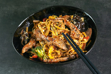 Asian noodles with meat on plate