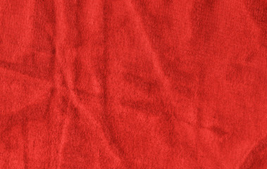 Bright red texture of binding fabric. Red textile background with natural folds. Close-up