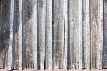 Old dry wooden gray wall vertical boards