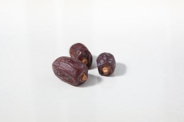 Dried dates fruits on white background, tasted sweet and chewy