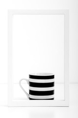 Black and white striped cup in white frame on white background