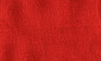 Bright red texture of binding fabric. Red textile background with natural folds. Close-up