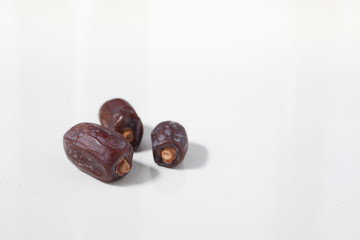 Dried dates fruits on white background, tasted sweet and chewy