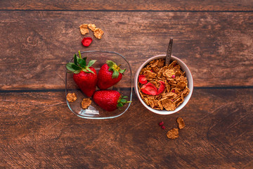 Cereal and fresh strawberries on table