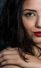 Close-up half face and body portrait of young beautiful woman