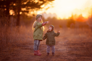 Fototapeta premium a walk at the children's brother and sister at sunset