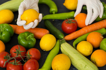 Choosing fruit with plastic medical gloves to protect from Covid-19 virus attack.