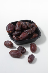 Dried dates fruits on white background, tasted sweet and chewy