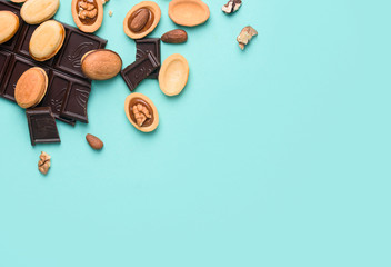 Homemade nuts with condensed milk, chocolate inside, walnuts and almonds. Nuts on a light blue background. A place for text.