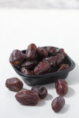 Dried dates fruits on white background, tasted sweet and chewy