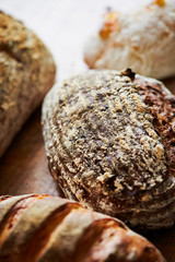 Various crusty bread on wooden background