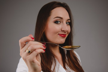 Young attractive woman eat chocolate, close up