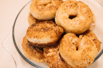 Homemade doughnuts with sugar on a white wooden table